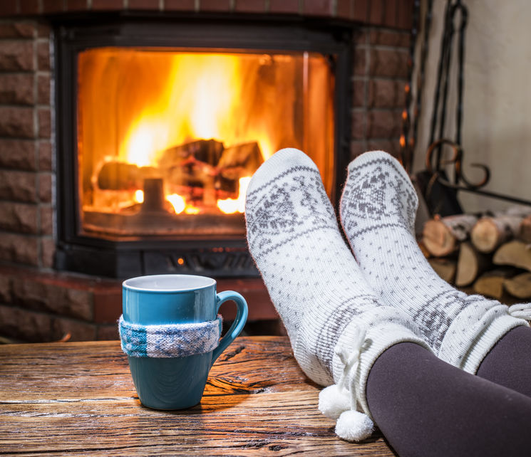 Feet with socks in front of fire